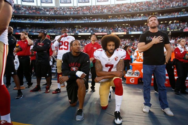 Then-teammates Colin Kaepernick (center) and Eric Reid knelt during the national anthem on Sept. 1, 2016. Former Green Beret Nate Boyer stood beside them in solidarity.