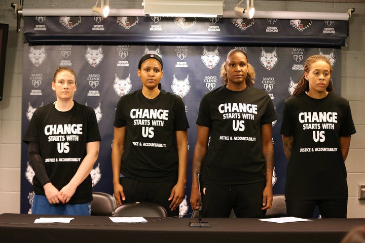 July 2016: Lindsay Whalen #13, Maya Moore #23, Rebekkah Brunson #32, and Seimone Augustus #33 of the Minnesota Lynx wear black shirts in protest against recent shootings and racial profiling.