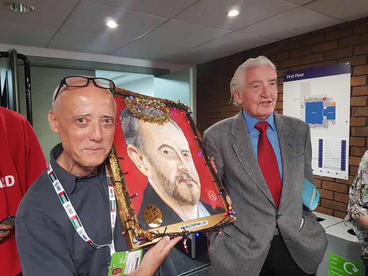 Labour member Paul Dawson shows off his Jeremy Corbyn artwork with Bolsover MP Dennis Skinner.