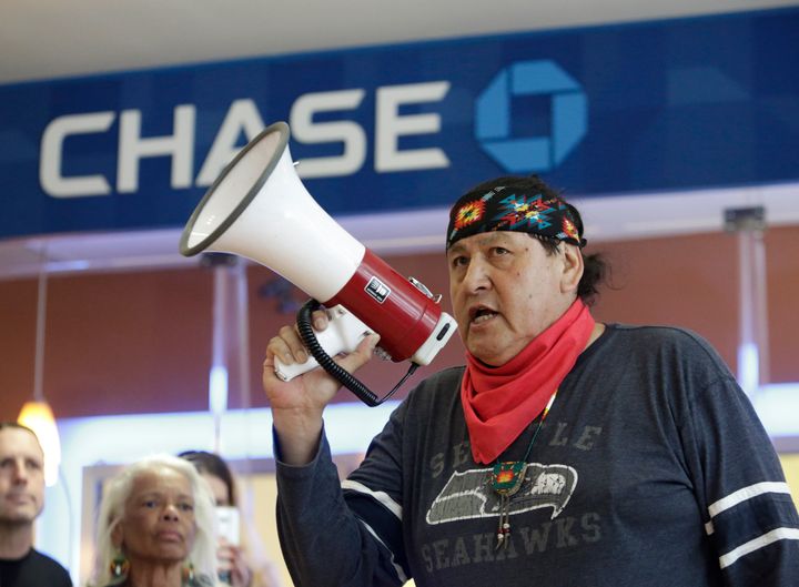 Raymond Kingfisher speaks as indigenous leaders and climate activists disrupt business on May 8 at a Chase Bank branch in Seattle to protest funding tar sands development and projects like the Keystone XL pipeline.