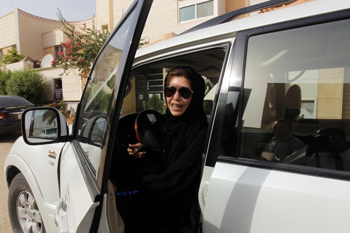 Azza Al Shmasani alights from her car after driving in defiance of the ban in Riyadh on June 22, 2011.