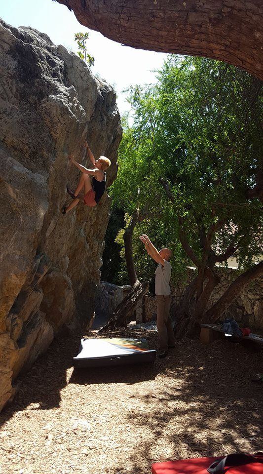 Maya Benepe climbing a natural boulder in Berkeley, CA