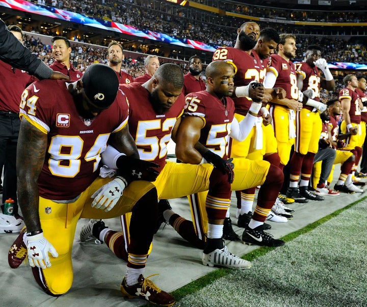 Washington Redskins tight end Niles Paul (84), linebacker Ryan Anderson (52) and linebacker Chris Carter (55) kneel with teammates during the national anthem before the game between the Redskins and the Oakland Raiders in Maryland on Sunday.