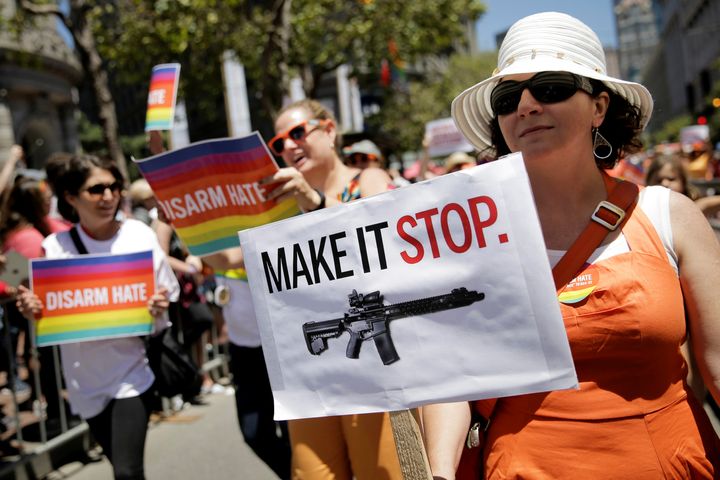 A woman holds a sign while marching with the Moms Demand Action for Gun Sense in America contingent at the San Francisco LGBT Pride Parade in San Francisco, California, U.S. June 26, 2016.