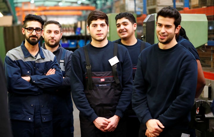 Refugees partake in a qualification class for German railway operator Deutsche Bahn.