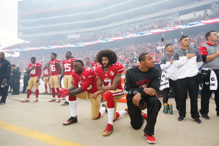 Eli Harold #58, Colin Kaepernick #7 and Eric Reid #35 of the San Francisco 49ers kneel on the sideline, during the anthem, prior to the game against the New York Jets at Levi Stadium on December 11, 2016 in Santa Clara, California. 