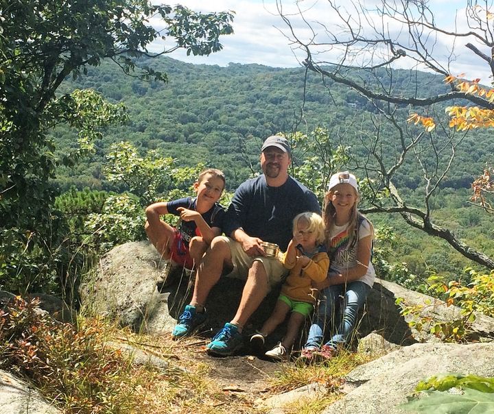 <p>Rebekah pictured with her father and two younger brothers on a family hike.</p>