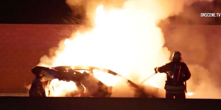 A vehicle carrying a family of three on a Los Angeles freeway caught on fire after a collision with an off-duty officer's vehicle, authorities said.