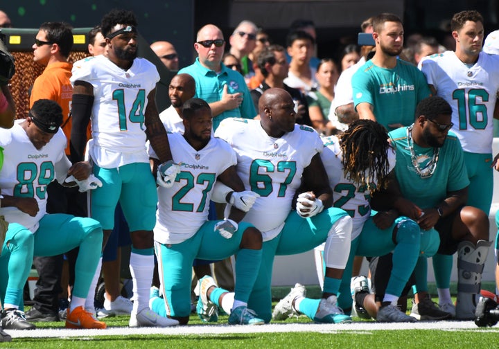 Some of the Miami Dolphins take a knee during the anthem prior to the game against the New York Jets at MetLife Stadium. 