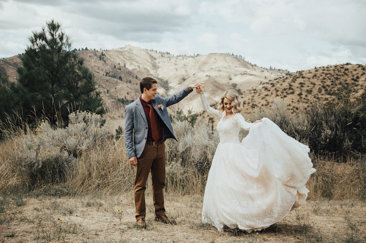 The bride poses with her husband in the timeless gown.