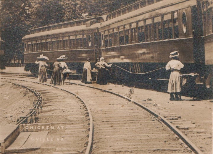 Waiter Carriers selling chicken dinners to train passengers. 