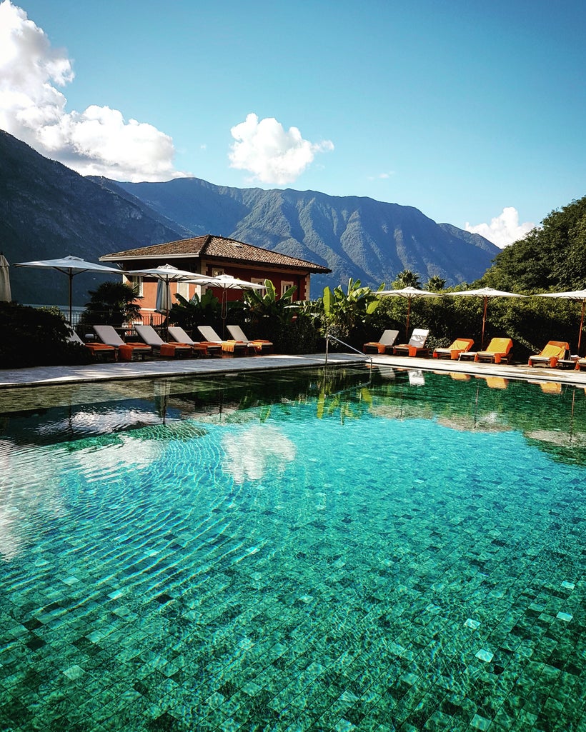 The heated and tranquil <em>Piscina dei Fiori </em>(pool among the flowers) is fringed with lounge chairs, umbrellas, and a l