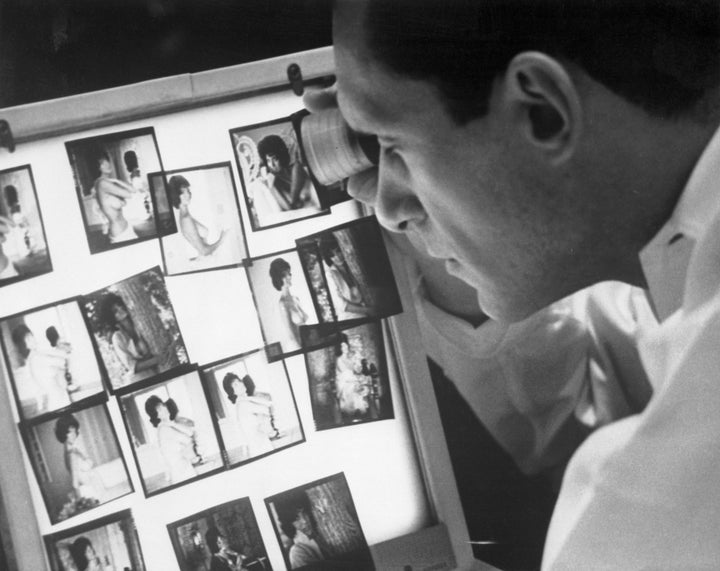 Hugh Hefner viewing photographs in his Chicago office.