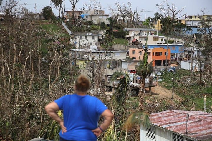 Irma Santiago surveys her in Corozal neighborhood as Puerto Ricans deal with the aftermath of Hurricane Maria on Wednesday.