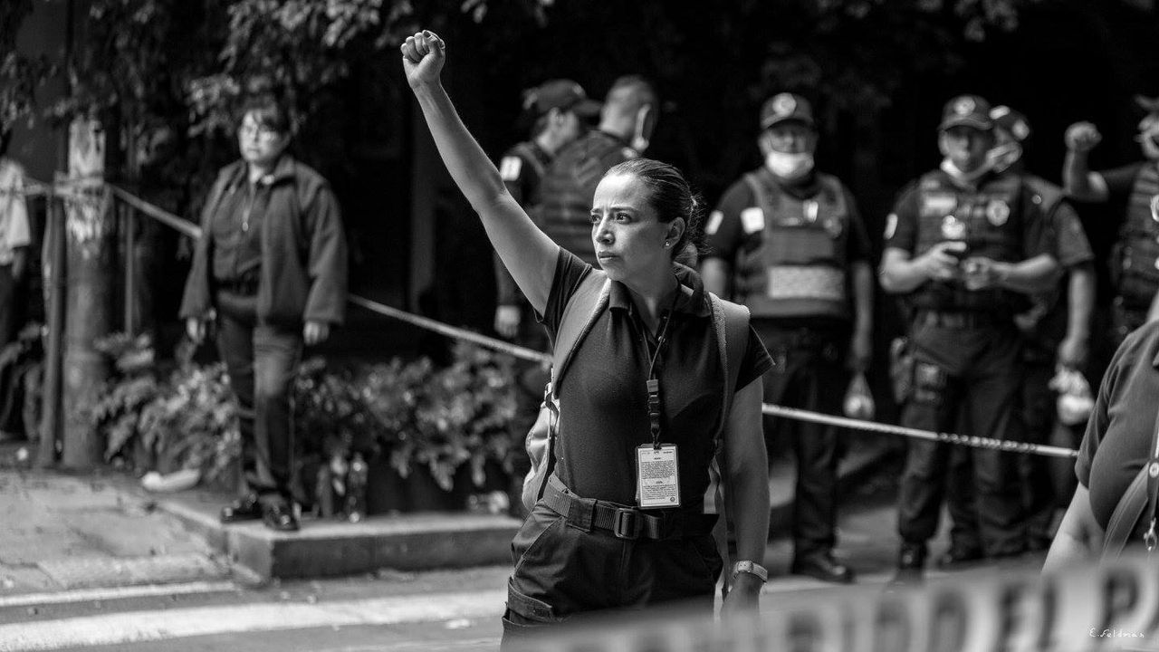 A woman raises her fist in the aftermath of a magnitude 7.1 earthquake that hit Mexico's capital, leveling buildings and killing hundreds.