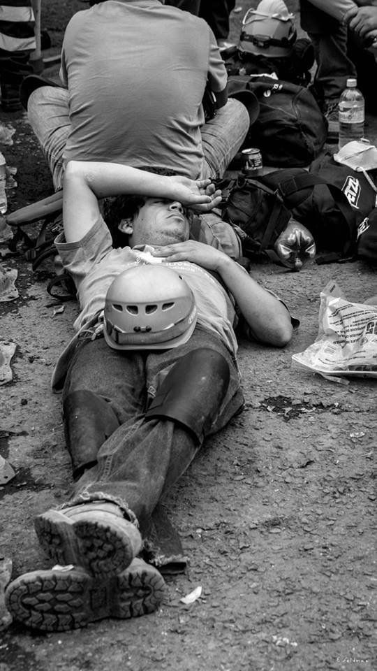 A rescue worker lies down for a moment of rest.