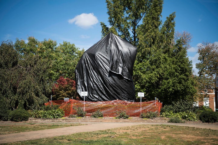 The statue of Confederate Gen. Robert E. Lee that sparked protests in August sits covered in plastic in Charlottesville, Virg