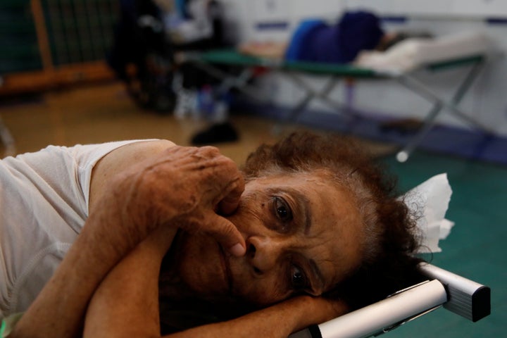 Hilda Colon wakes up after sleeping in a shelter set up at the Pedrin Zorrilla coliseum, after Hurricane Maria destroyed the