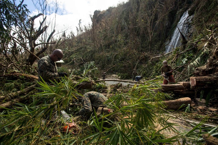 <p>Efforts to clear roads to enable the distribution of relief supplies is ongoing. U.S. Marines with Battalion Landing Team 2nd Battalion, 6th Marine Regiment, 26th Marine Expeditionary Unit (MEU), conduct route clearing with Navy sailors and local civilians to assist in relief efforts for victims of Hurricane Maria in Ceiba, Puerto Rico, Sept. 25, 2017. </p>