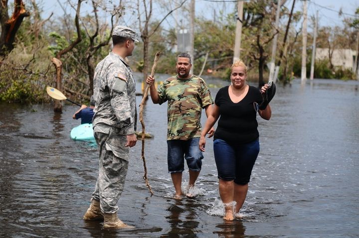 <p>Citizen- Soldier help a couple getting away of the flooded areas in Condado, San Juan, Puerto Rico after the path of Hurricane Maria.</p>