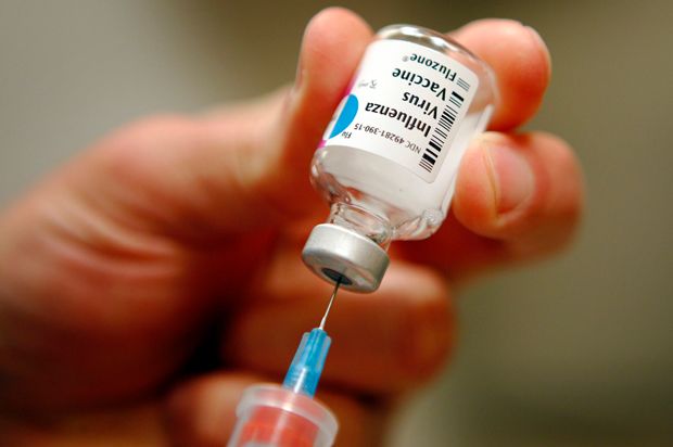 A nurse prepares an injection of the influenza vaccine at Massachusetts General Hospital in Boston, Massachusetts.