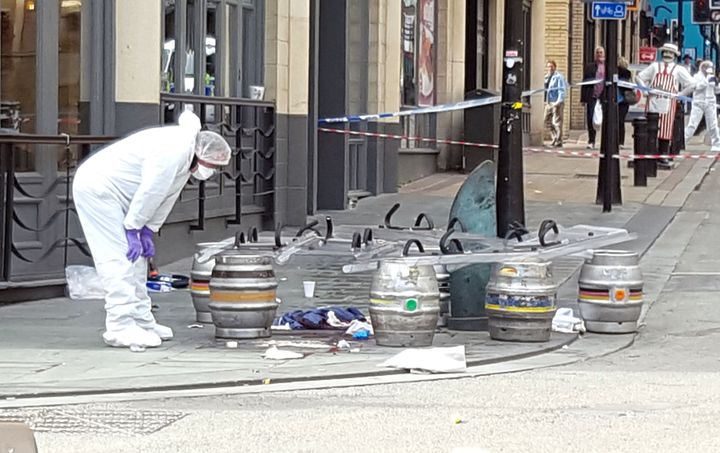 Forensics at the scene in Sheffield city centre where five people have been injured in two linked stabbing incidents
