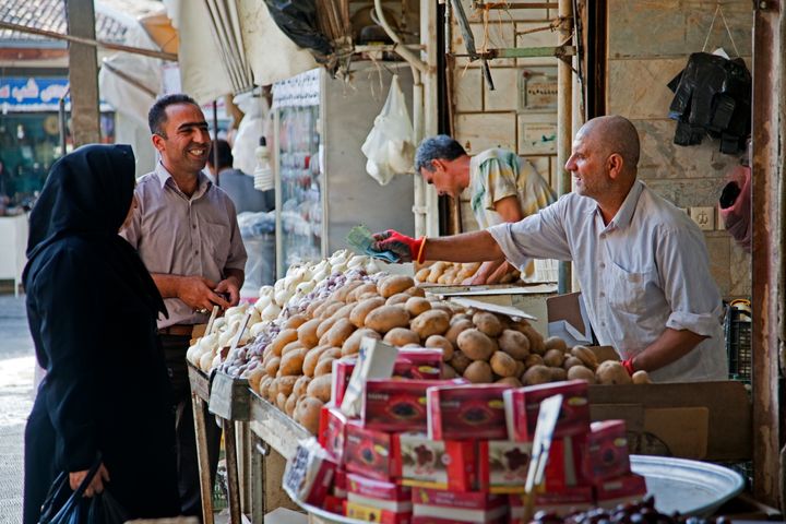 Iranians buy food at a vegetable market in Gurgan, Iran.&nbsp;