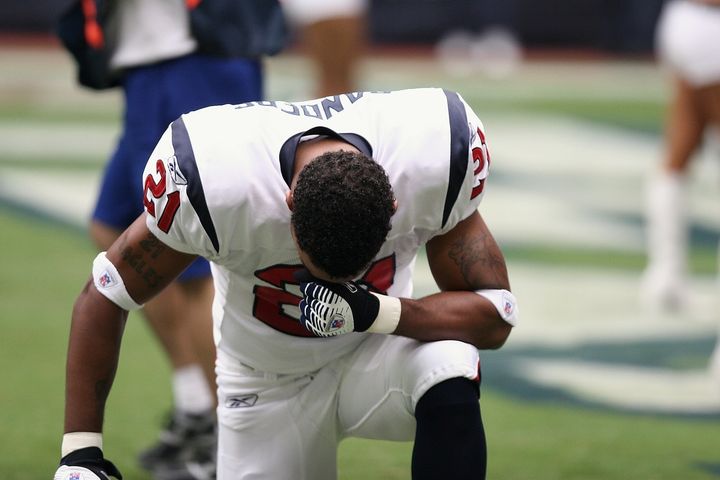 Professional football player takes a knee