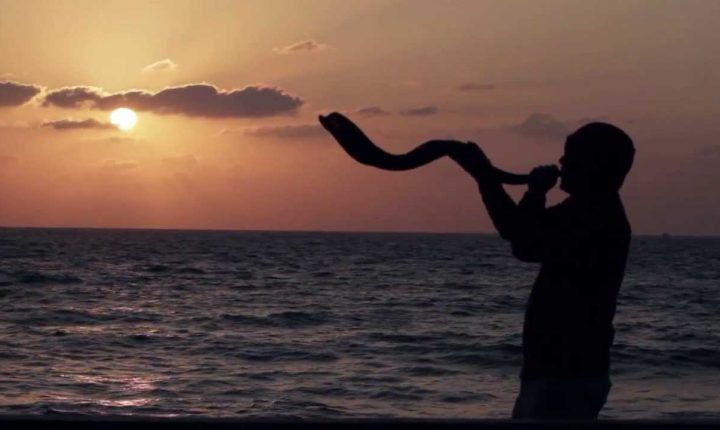 Man Blowing Shofar at the ocean, close of 10 Days of Awe www.shofar.FM