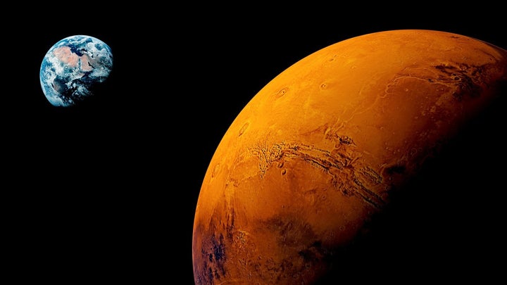 <p>The Red Planet, in a not-to-scale view with far away Terra.</p>
