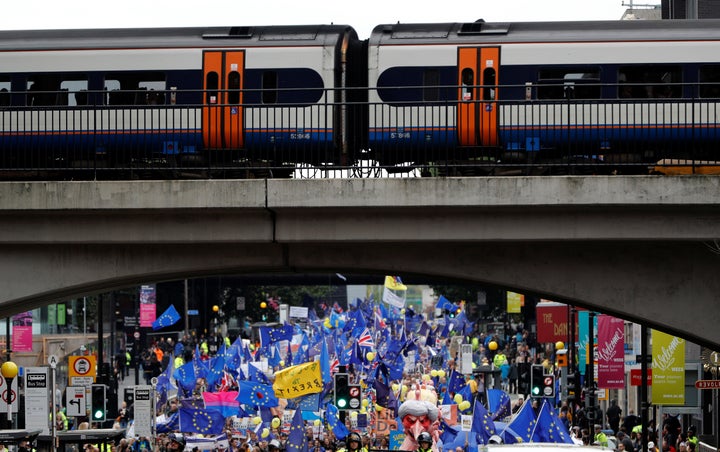 Demonstrators march through the city during a protest on the opening day of the Conservative Party Conference, in Manchester