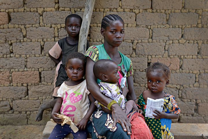 Golden Marlenue, 27, outside her home with her children. The two youngest children, Naomi and Athanase, are both malnourished. Concern helped to re-open the nearby Ndanga Health Post so that the children can now get the treatment and support they need.