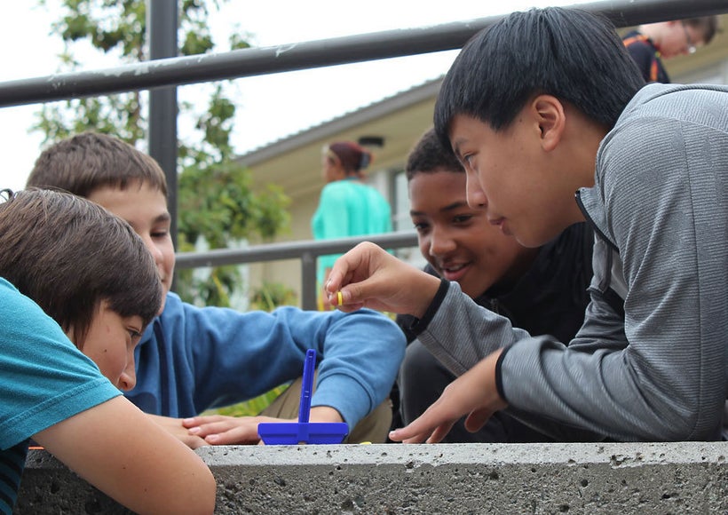 With no cell phones to toy with, middle school students play a game after lunch at Korematsu Middle