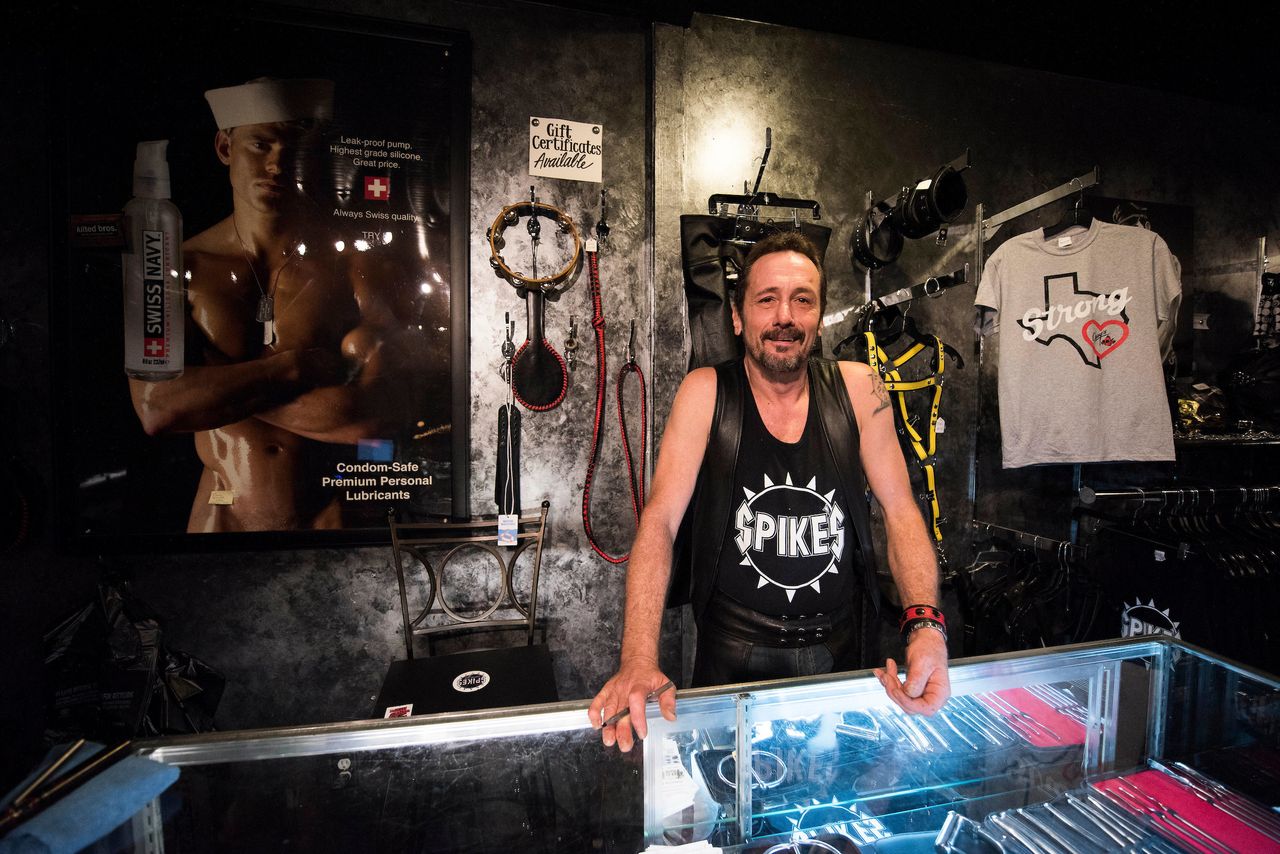 Rod Caldwell, co-owner of Spike's Leather Club in Birmingham, Alabama, stands behind a glass counter in their boutique. 