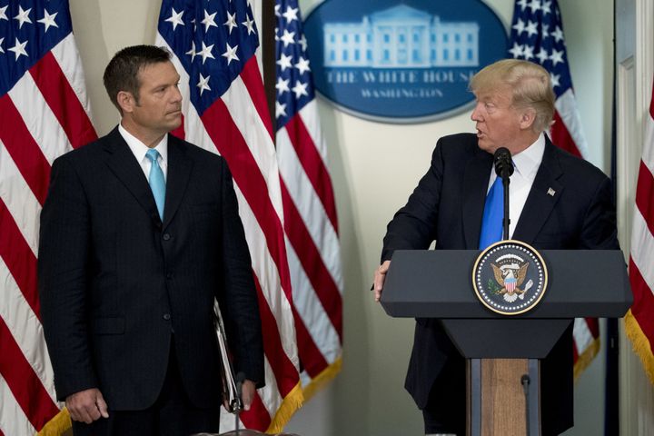 President Donald Trump speaks as Kris Kobach, Kansass secretary of state, listens during the initial meeting of the Presidential Advisory Commission on Election Integrity in Washington, D.C., July 19, 2017.