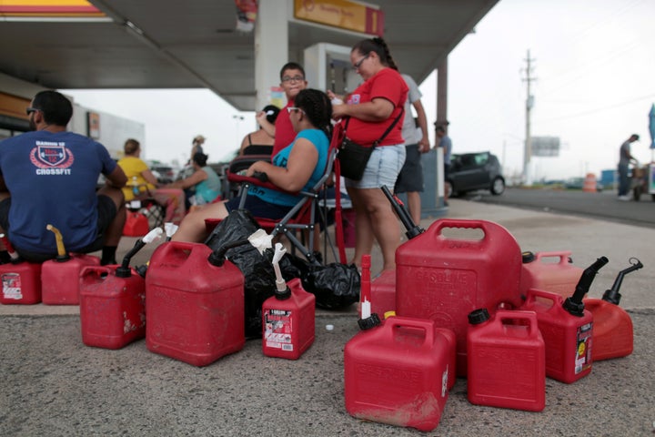 People in San Juan, Puerto Rico wait at a gas station to fill up their fuel containers, in the aftermath of Hurricane Maria.