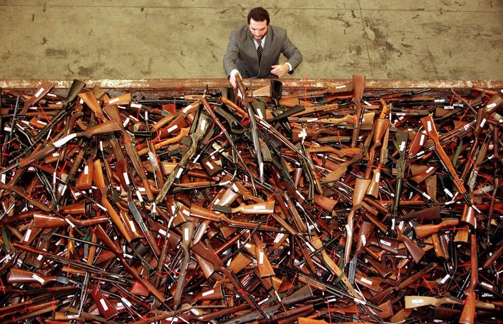 Mick Roelandts, firearms reform project manager for the New South Wales Police, looks at a pile of about 4,500 prohibited firearms in Sydney that have been handed in over the past month under the Australian government's buy-back scheme; a total of 470,000 guns have been collected nationally. The scheme was set up due to tighter gun laws brought in after the April 1996 Port Arthur massacre in which 35 people died