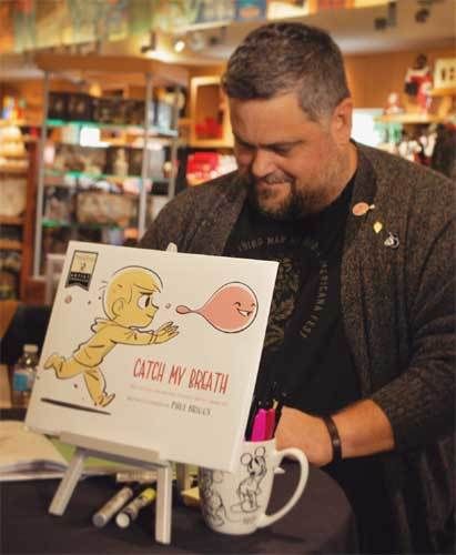 <p>Paul Briggs at a signing for his new picture book, “Catch My Breath”</p>