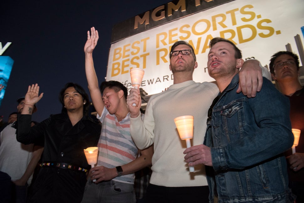 Mourners show support during a candlelight vigil.