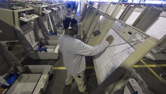 A technician prepares voting machines to be used in last year’s election in Philadelphia. Many state and local governments ha
