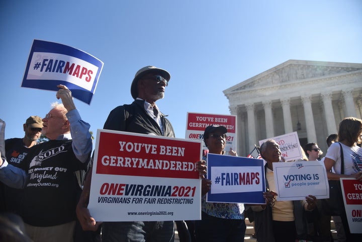 Demonstrators gather outside of the United States Supreme Court during oral arguments in Gill v. Whitford to call for an end to partisan gerrymandering.