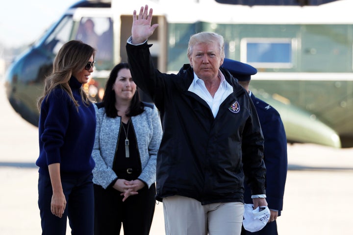 President Donald Trump waves to reporters as he and first lady Melania Trump arrive at Joint Base Andrews, Maryland, to board Air Force One for travel to Puerto Rico on Oct. 3, 2017.