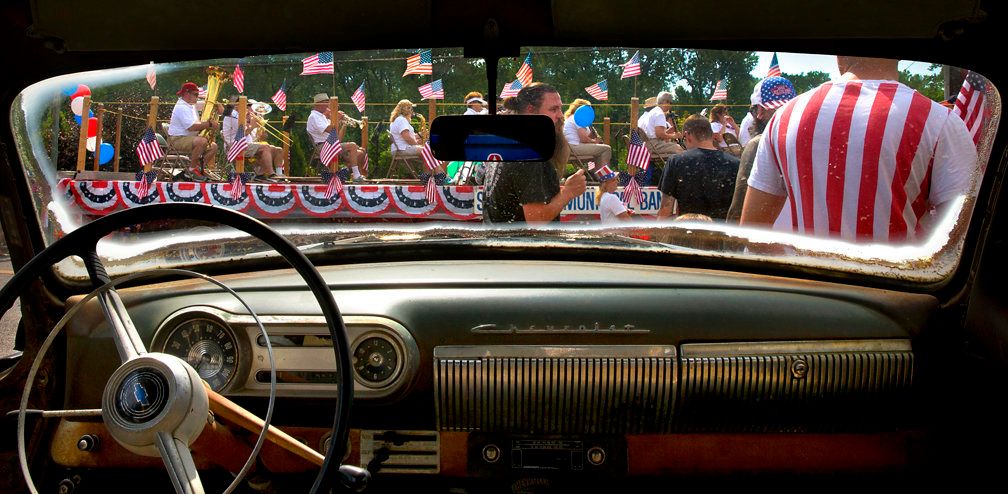 Members of the St. Charles Municipal Band roll past a 1953 Chevy on the lot of McNeil Motor Cars as the St. Charles Jaycees Riverfest Parade makes its way through the Frenchtown neighborhood on Tuesday, July 4.