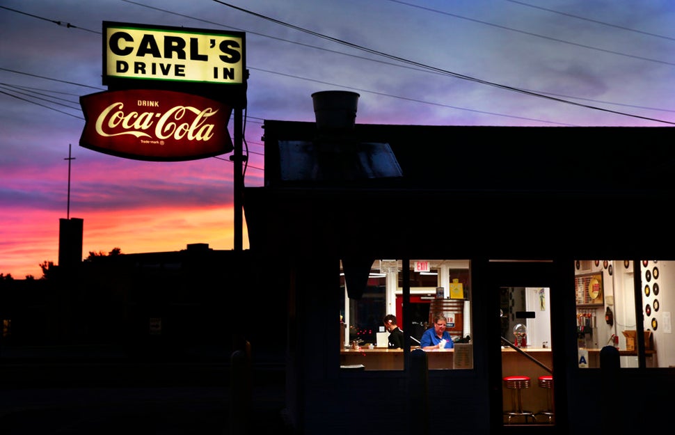 Jason Apple and Pam Martin clean up after closing for the day at Carl's Drive-In in Brentwood, Missouri, on Aug. 18, 2016. Th
