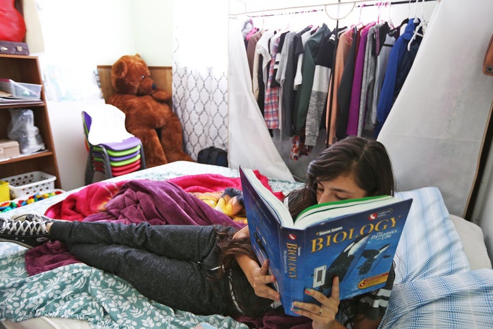 <p>Alison often studies on the bed that she shares with her parents who work in the nearby strawberry fields.</p>