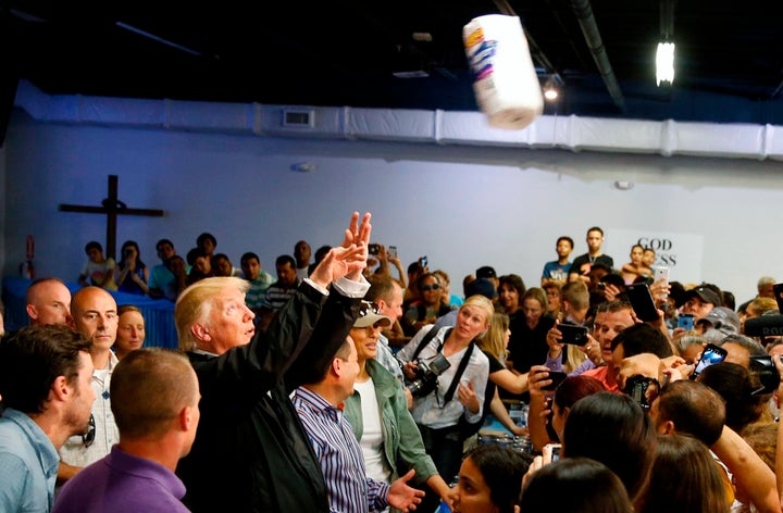 President Trump chucks rolls of paper towels into a crowd of local residents at Calgary Chapel in San Juan on Oct. 3.