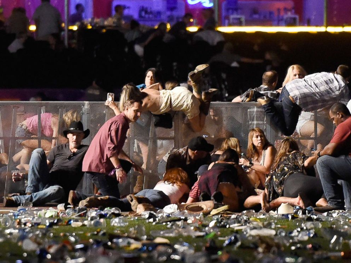 <p>People scramble for shelter at the Route 91 Harvest country music festival after apparent gun fire was heard on October 1, 2017 in Las Vegas, Nevada. </p>