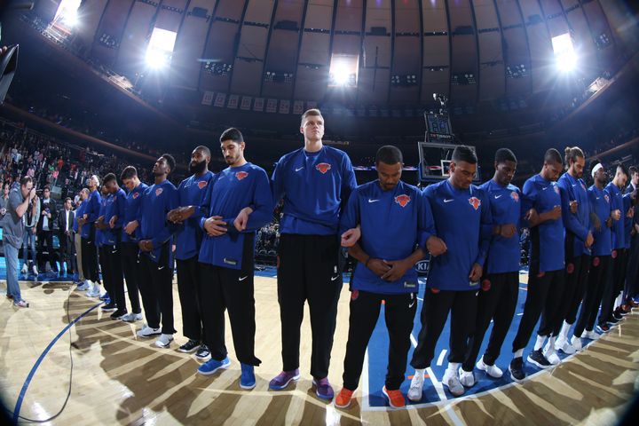 The New York Knicks stand for the national anthem with linked arms before a preseason game on Oct. 3, 2017.