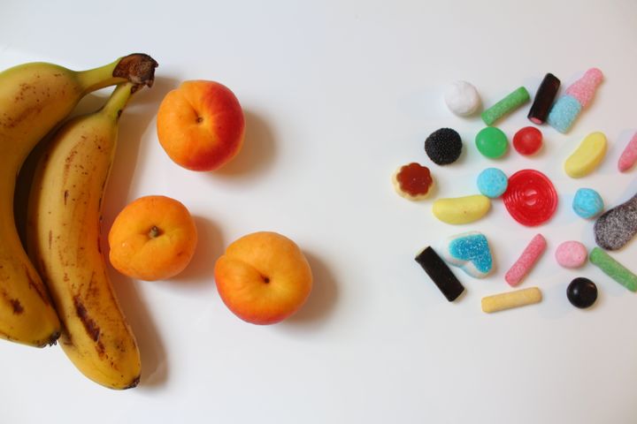 Fruits versus group of candies Even_lys via Getty Images