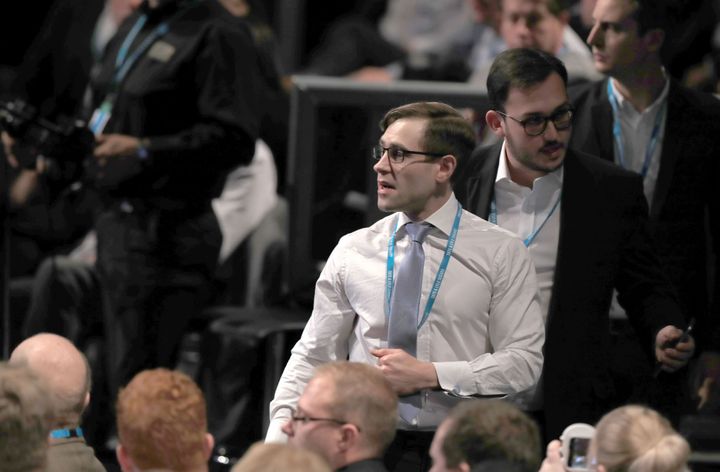 Comedian Simon Brodkin, also known as Lee Nelson is led out of the Conservative Party Conference hall.
